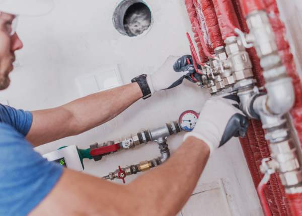 Man working on commercial plumbing.